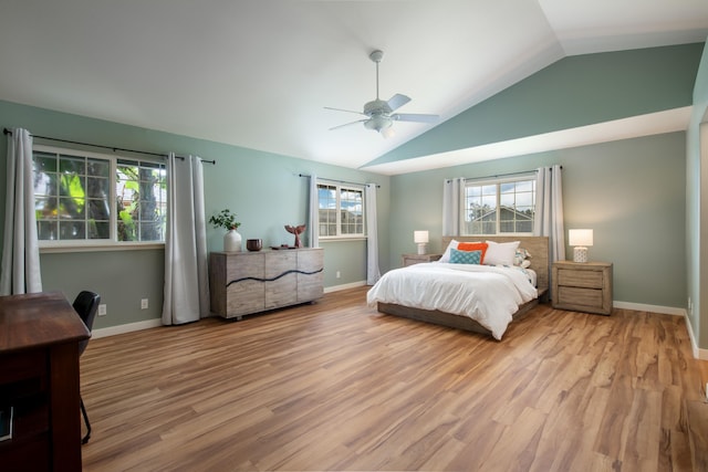 bedroom with ceiling fan, lofted ceiling, and light wood-type flooring