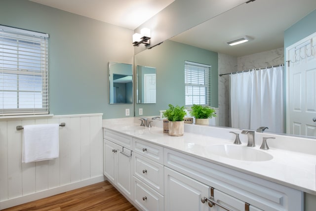 bathroom with vanity, hardwood / wood-style flooring, and walk in shower