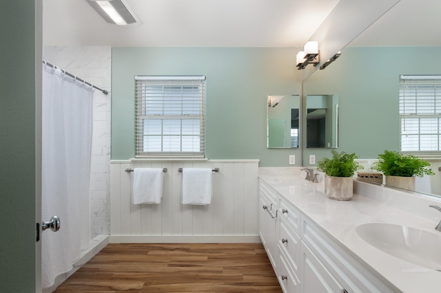 bathroom with hardwood / wood-style flooring, vanity, and a shower with curtain