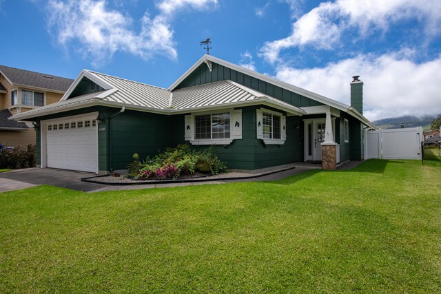 view of front of home with a garage and a front yard