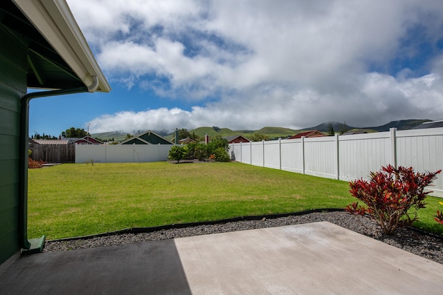 view of yard featuring a patio and a mountain view