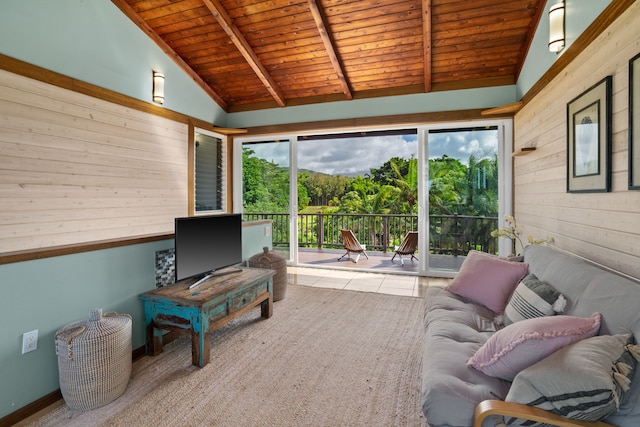 living room featuring beam ceiling, wooden ceiling, a healthy amount of sunlight, and tile patterned flooring