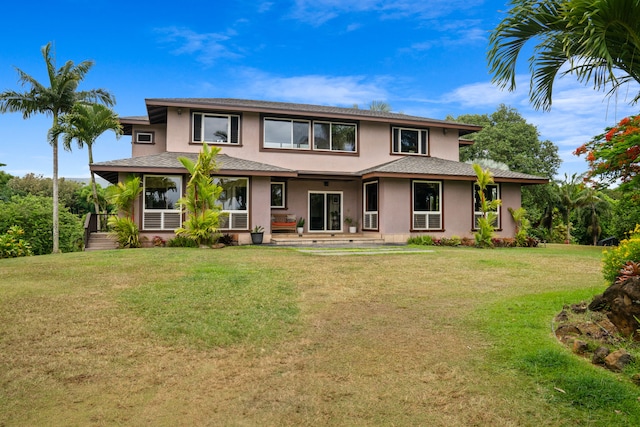 prairie-style house featuring a front lawn