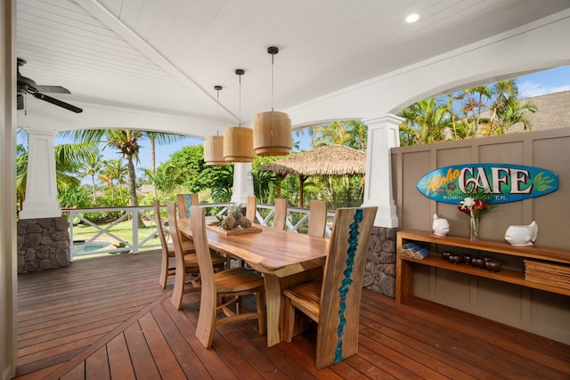 exterior space with dark wood-type flooring, ceiling fan, decorative columns, and wooden ceiling