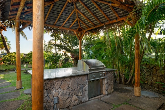 view of patio featuring a gazebo, an outdoor kitchen, and grilling area