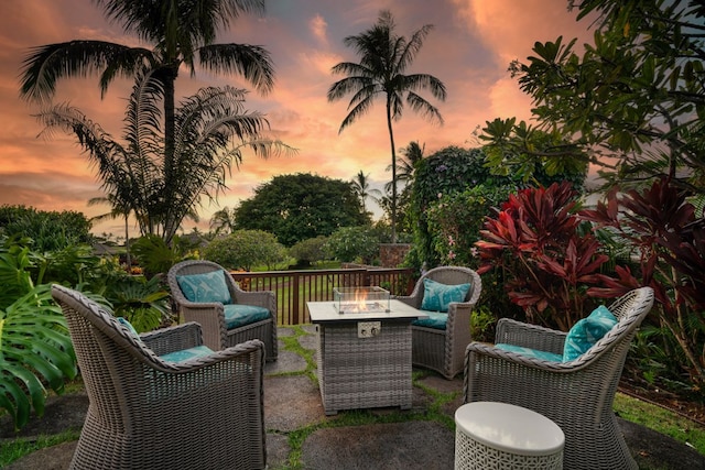 patio terrace at dusk featuring an outdoor living space with a fire pit