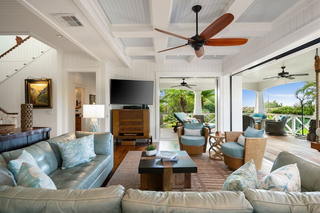 living room featuring beamed ceiling and hardwood / wood-style floors