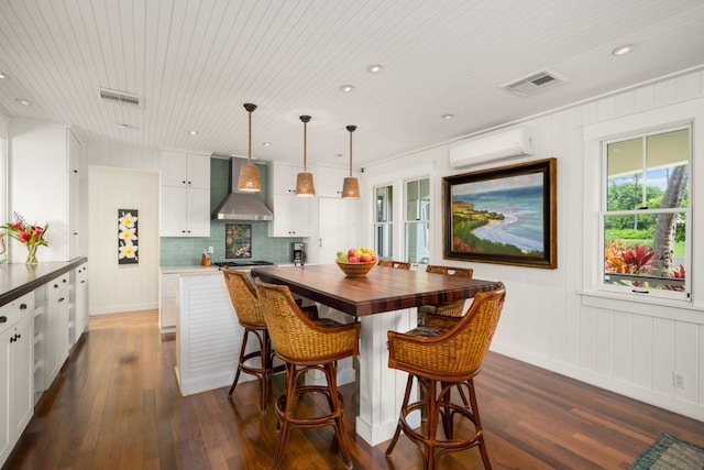 dining area with wooden ceiling, dark hardwood / wood-style floors, and an AC wall unit