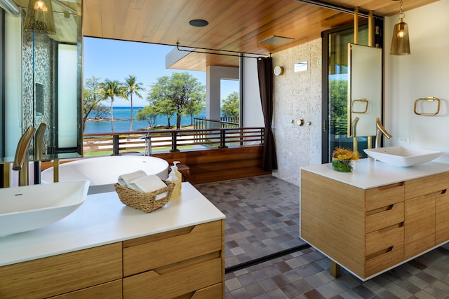 bathroom featuring dual vanity, a water view, tile patterned flooring, and wooden ceiling