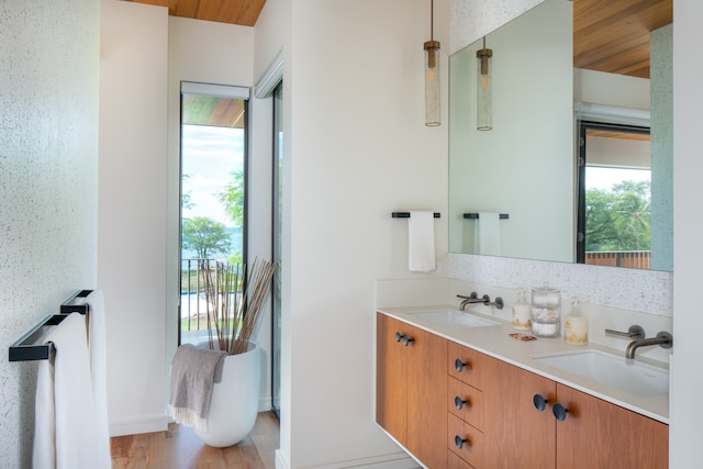 bathroom with dual vanity, hardwood / wood-style floors, and wood ceiling