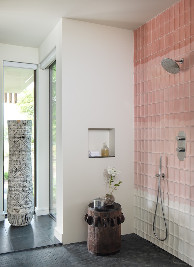 bathroom with tile patterned flooring, tile walls, and a shower