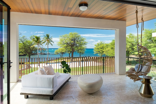 exterior space with wood ceiling and a water view