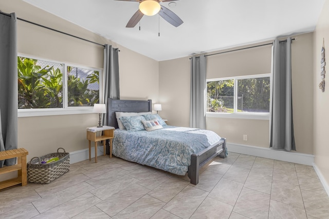 tiled bedroom with multiple windows and ceiling fan