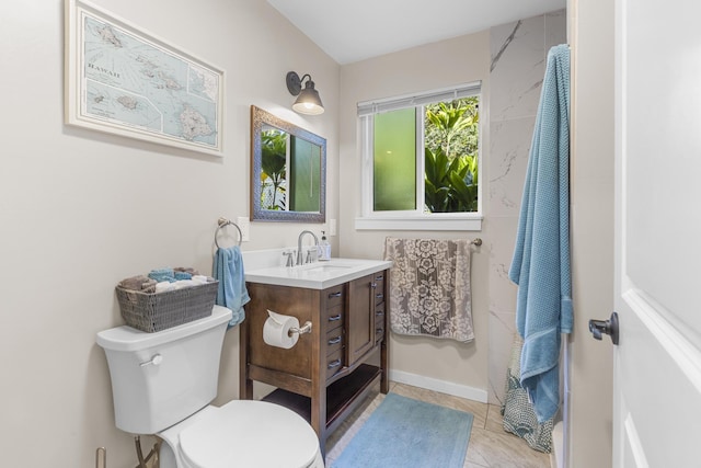 bathroom with tile patterned flooring, vanity, and toilet