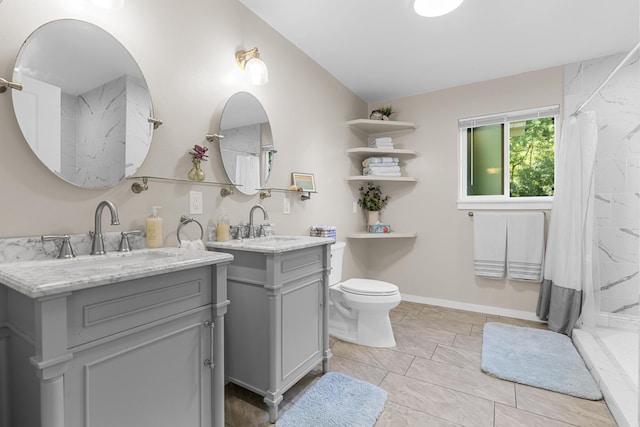 bathroom with vanity, curtained shower, and toilet