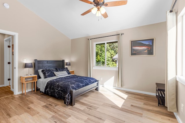 bedroom featuring lofted ceiling, ceiling fan, and light wood-type flooring