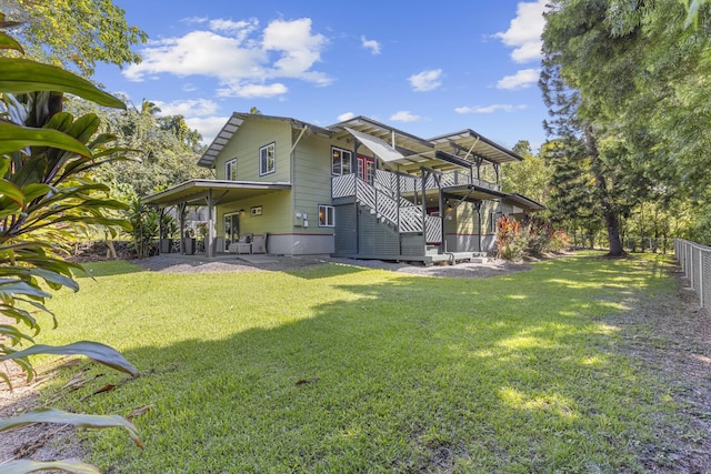 back of property featuring a patio and a lawn