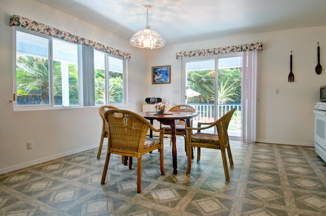 dining area with an inviting chandelier