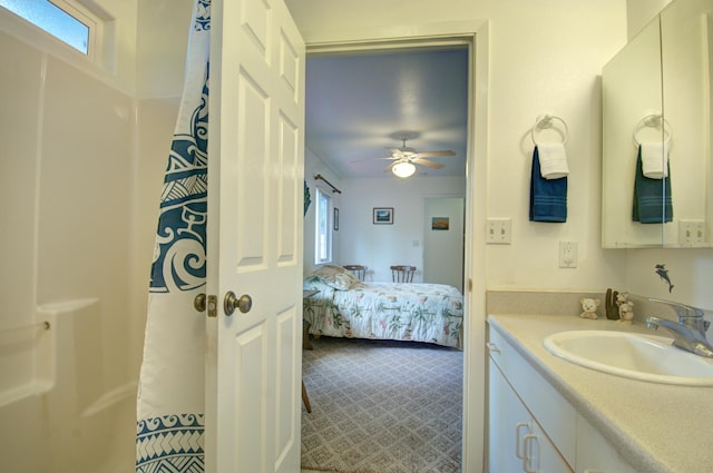 bathroom with ceiling fan, walk in shower, and vanity