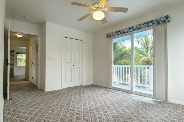 unfurnished bedroom featuring ceiling fan, a closet, access to exterior, and light carpet