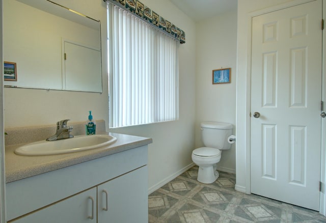 bathroom with toilet and vanity