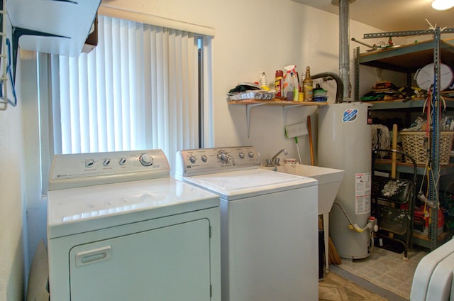 laundry area featuring gas water heater and washing machine and dryer