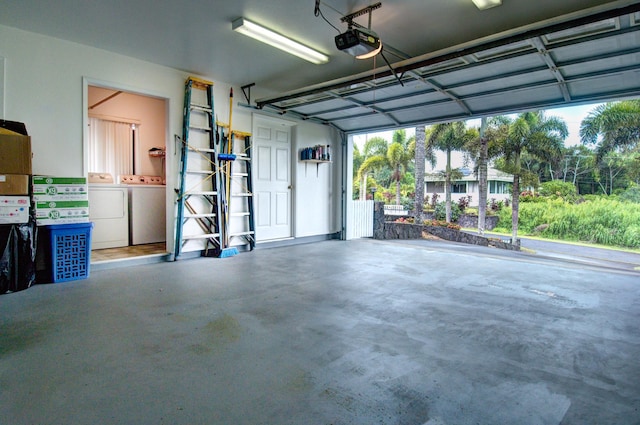 garage featuring washer and clothes dryer and a garage door opener