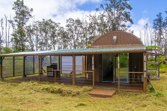 rear view of property featuring a lawn