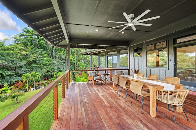 deck with a lawn and ceiling fan