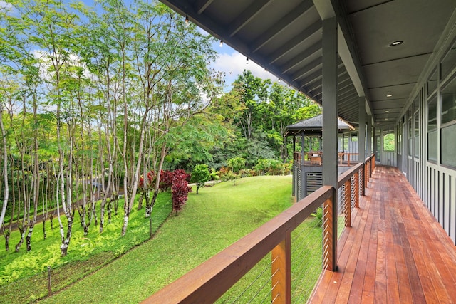 wooden terrace with a yard