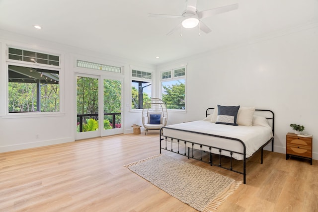 bedroom featuring ceiling fan, ornamental molding, and light hardwood / wood-style flooring