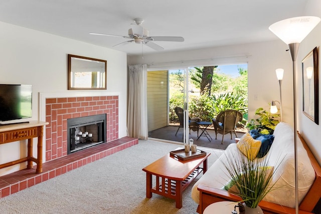 living room featuring ceiling fan, a fireplace, and carpet