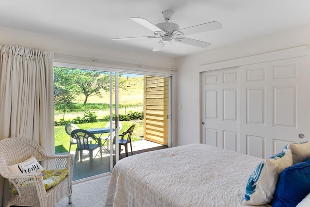 carpeted living room with ceiling fan and a fireplace