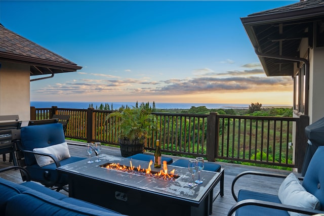 deck at dusk with an outdoor fire pit