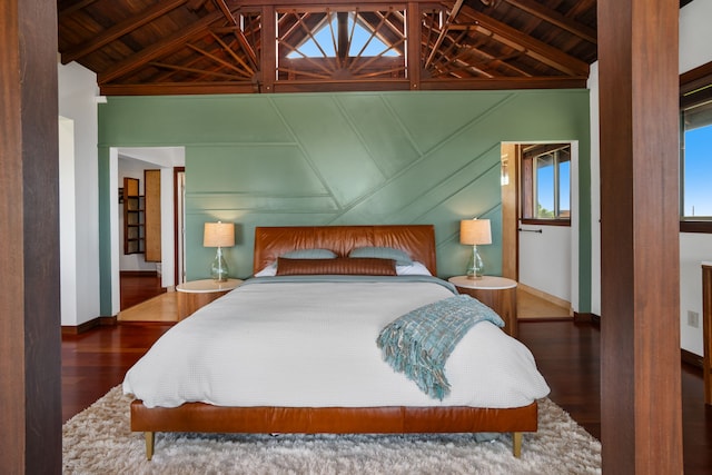 bedroom featuring dark hardwood / wood-style flooring, vaulted ceiling with beams, and wood ceiling