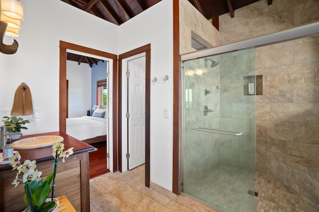 bathroom with wooden ceiling, a shower with door, and vaulted ceiling with beams