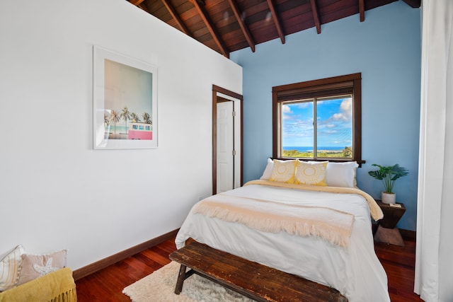 bedroom with dark wood-type flooring, wooden ceiling, and lofted ceiling with beams