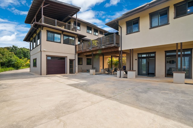 rear view of property with a garage