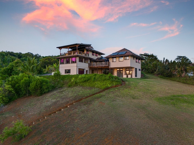 view of front of house with a lawn and solar panels