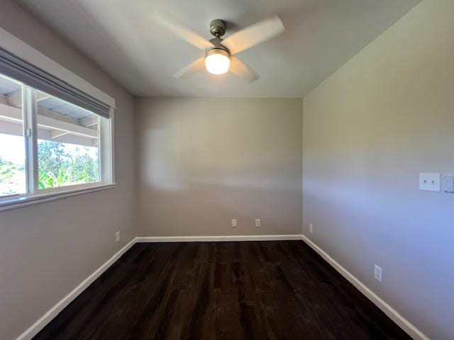 spare room featuring ceiling fan and dark wood-type flooring