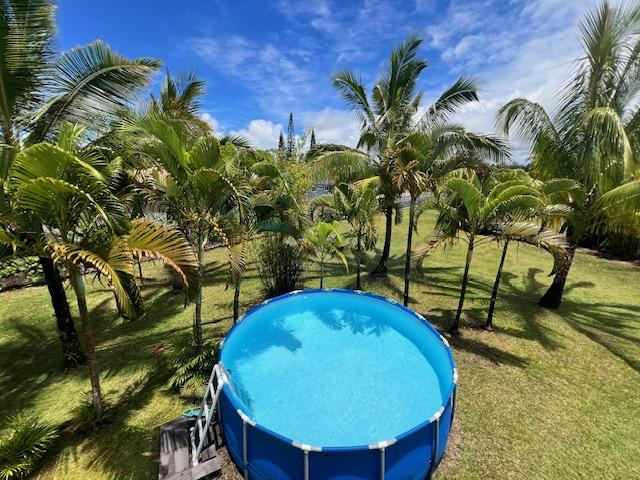 view of pool featuring a yard