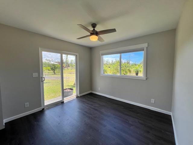 unfurnished room with ceiling fan and dark hardwood / wood-style flooring