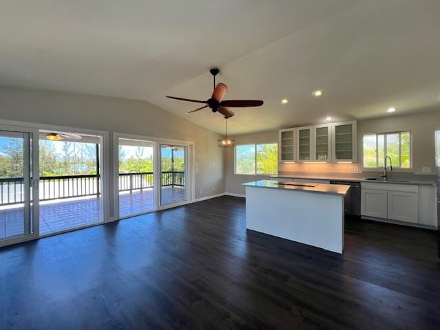 kitchen with white cabinetry, ceiling fan, black dishwasher, sink, and a center island