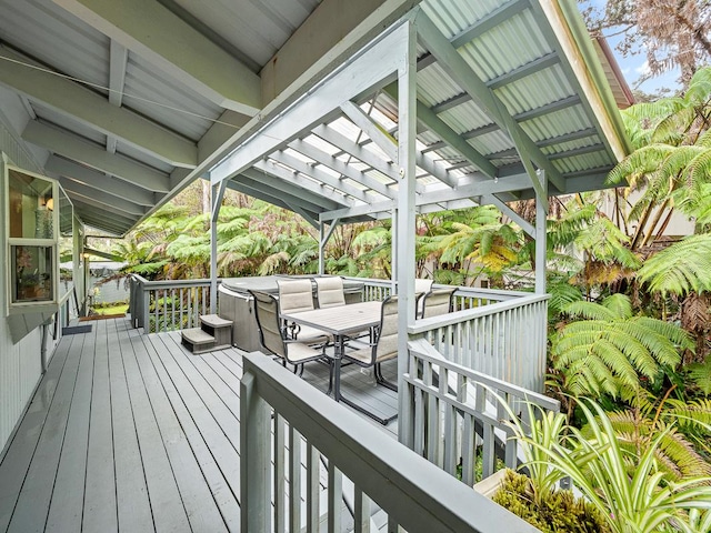 wooden deck with a hot tub