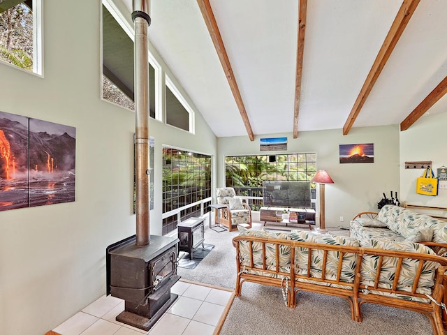 tiled living room with a wealth of natural light, lofted ceiling with beams, and a wood stove