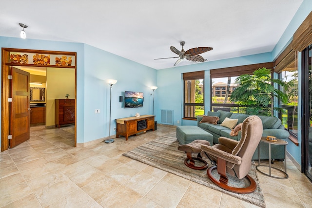 living room with ceiling fan and light tile patterned floors