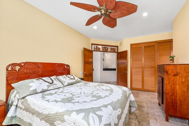 tiled bedroom with ceiling fan and a closet