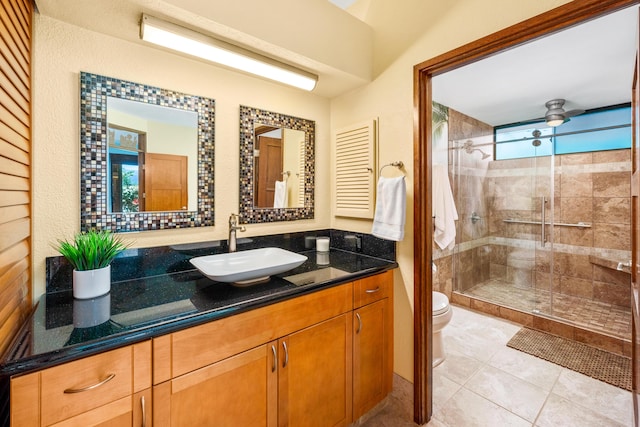 bathroom featuring a wealth of natural light, toilet, an enclosed shower, and vanity