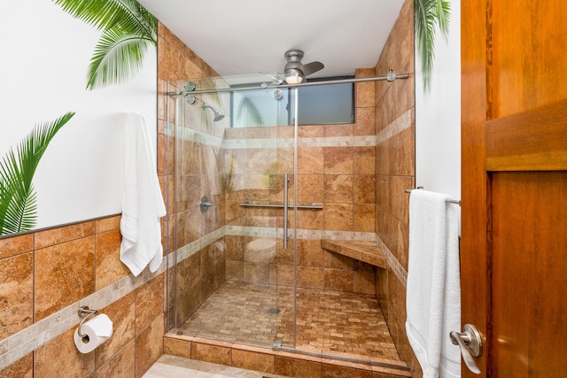 bathroom featuring an enclosed shower and ceiling fan