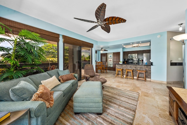 tiled living room with ceiling fan